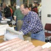 Tonasket dentist and Kiwanian Rob Nau sells sausage at the dinner. The Kiwanis club sold bulk meat in addition to plates of cooked food. Photo by Amy Veneziano