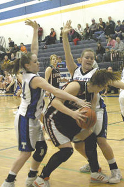 Photo by Terry MillsTigers Katy Keeton and April Webber make a tough defense against Omak.