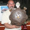 <p align="right"> Photo by Gary DeVon</p><p><font size="3">Jerry King, a self-described member of the Turtle Clan, shows off the turtle his wife bought for him during the auction at the Habitat for Humanities benefit. The event, held at the River’s Edge