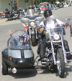 


<p></noscript><i> Photo by Gary DeVon</i>
<p>    Jackson Gregg, gets a ride in a sidecar from Verna Madison, a member of the Columbia River Harley Owner’s Group. The fourth-grader, who had an operation last year for a brain tumor, was helped by the group which ra” title=”362a” width=”” height=”” class=”size-FULL”>
<p class=