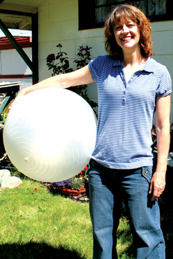 Photo by Amy Veneziano	Fitness instructor Melody Williams is armed and ready to work – out, that is – with a Swiss ball near her temporary Tonasket home. 