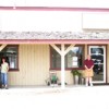 <p align="right"><i> Photo by Gary DeVon </i></p><p>Colleen Brown (left) stands next to the new temporary location of the Washington State Liquor Store. Next door is Steve Smith and his Grange Insurance Agency. Both businesses had to move after the buildi