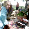 File Photo Mariah Cornwoman, owner of CWRay, LLP Farm and Forest Products attempts to temp a couple of festival-goers with one of her many garlic-based products at last year’s Okanogan River Garlic Festival in Tonasket. The festival, sponsored by t