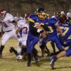 Photo by Terry MillsSenior Justin Mann protects the football as he works his way through Okanogan and Tonasket players during Tonasket’s home game against Okanogan on Friday, Oct. 24.
