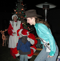 Miss Tonasket Rodeo Queen 2009 Kelsey Gallas helped lead children to Santa during Winter Fest on Friday, Dec. 5 so that they could tell him what they want for Christmas.Photo by Emily Hanson