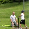 Photo by Emily HansonTim Cork, the head softball coach for Tonasket High School, teaches one the girls on the last day of the sports camp how to hit a softball off the tee properly.