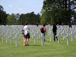 Row after row of white crosses and Stars of David, fill the Normandy American Cemetery in France. The burial ground overlooks Omaha Beach, site of part of the D-Day Invasion. Photo by Gary DeVon