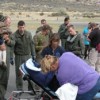 Oroville Ambulance Crew members Debora Donohue, Lisa Bordwell and Brad Calico prepare to load a gurney with a female believed to be suffering from hypothermia. The child and the two male sujects (seen here in camo shirt and bright blue shirt) were also tr