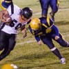 Hornet Caleb Whiteaker goes for the tackle. He and Charlie Demartino teamed up on defense to keep Bridgeport contained all night by not letting them get outside, according to Coach Tam Hutchinson. Photo by Eric Teela