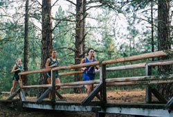 Tonasket cross country runner Emmy Hickman crossing a bridge on the Colville Course on Saturday, Oct. 17. Hickman finished the 5,000 meter course in 23rd place with a time of 23:13. Submitted by Bob Thornton