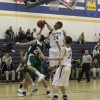 Tonasket senior Terrell Cross jumps up to stop Chelan freshman Michael Amsel, Jr. (20) from scoring during Tonasket’s home loss to Chelan on Tuesday, Dec. 15. Also shown is junior Corbin Moser (32). Photo by Terry Mills