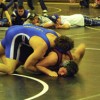 Josh Lofthus, Lee Leavell and Justin Dellinger watch as teammate Keegan McCormick wrestles Raleigh Beckstrom, a senior from Reardon High School, at the Royal Tournament on Tuesday, Dec. 29 in the 171 pound weight class. McCormick won the match despite Bec