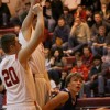 Tonasket sophomore John Stedtfeld crouches down to make a jump shot despite two tall Cascade defenders preparing to block the shot during Tonasket’s loss to Cascade on Saturday, Jan. 16. Photo by Ian Dunn