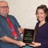 Oroville Elementary School Principal Joe Worsham presents Julie Schildgen with the Upper Okanogan 'Teacher of the Year' plaque from Wal-Mart Corporation. Submitted photo