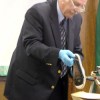 Detective Mike Murray holds up Michelle Kitterman's left shoe, which was found near her body, for the jury to see as evidence toward the end of testimony Monday, April 19. Murray also showed the shirt, jacket, jeans and bra Kitterman was wearing the night