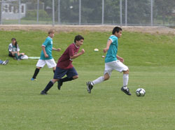 A Tonasket U15 soccer player on the Spectacle Lake Resort team kicks the ball down the field as an opponent from the Oroville Discount Fireworks team pursues him during the Youth Soccer Tournament on Saturday, May 22. The Spectacle Lake Resort team won th