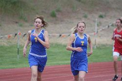 Tonasket sophomore Kyndra Dellinger (left) and junior Jessica Spear running together in the 1600 meter race at the District Six 1A Championship on Friday, May 21. Spear finished in second place at 5:46.85, qualifying her for a trip to the state meet, whil