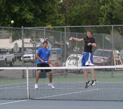 Tonasket senior Karl Bharucha (left) stays ready for his Okanogan opponents to send the ball back his way after his teammate, senior Damon Sprague, sent it flying over the net. Bharucha and Sprague won the match 6-1, 6-3 but lost in the finals match to th