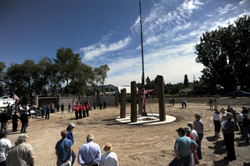 Many people gathered to listen to speeches and celebrate the raising of the American Flag on the 50-foot flagpole at the U.S. Armed Forces Legacy Project. Photo by Gary DeVon