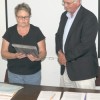 School Director Tedi Lynn Fletcher, chairwoman of the school board, presents a plaque to Dr. Ernie Bartelson commemorating his 13 years as superintendent for the Oroville School District. He was also presented with gifts from the board, including a “Str