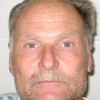 James Joel Landis, still in hospital garb after being released from Central Washington Hospital, in his booking photo. Landis has been charged with Attempted first degree Murder, Assault with a Deadly Weapon and Harassment Threats to Kill.