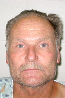 James Joel Landis, still in hospital garb after being released from Central Washington Hospital, in his booking photo. Landis has been charged with Attempted first degree Murder, Assault with a Deadly Weapon and Harassment Threats to Kill.