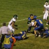 Tonasket senior linebacker Keegan McCormick wraps up Chelan junior wide receiver Cole Schwartz five yards from the goal line with help from fellow Tigers during Tonasket’s home game on Friday, Oct. 22. Photo by Emily Hanson