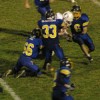 Tonasket senior linebacker Dustin Silverthorn (33) wraps up an Okanogan Bulldog with the help of sophomore linebacker Dalton Wahl (66) as senior linebacker Keegan McCormick (6) heads in to help. Also on the way to help with the tackle are senior defensive