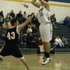 Tonasket senior Brandon Clark makes a jump shot over a Bridgeport defender during the Tigers’ home game against Bridgeport on Tuesday, Dec. 7. Photo by Emily Hanson