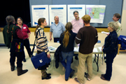 Members of the public speak with federal and state agency officials and check out materials relating to the EIS for Echo Bay Gold Exploration Company’s proposed gold exploration on Buckhorn Mountain. The company, part of Toronto-based Kinross Gold, want