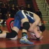 Tonasket senior Peter Williams curls over Omak’s Sammy Trudeaux in an effort to roll him to his back during the semi-final round of the 140 pound weight class at the District 6 wrestling tournament in Omak on Saturday, Feb. 5. Williams lost the round 5-
