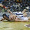 Tonasket senior Keegan McCormick smiles at his coaches during his first round in the 171 weight class of the 1A Division at the 2011 Washington State Mat Classic XXIII Championship on Friday, Feb. 18 as he successfully does the leg ride-turk move against