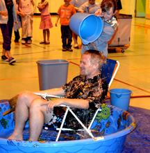 Oroville Elementary Principal Gary Pringle gets a bucket of water dumped over his head as a reward to the students who read 7,621 books in the Principal’s Challenge. Submitted photo