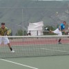 Senior Brett Hendrick serves the ball to his Liberty Bell opponents during the final round of the District 6 tennis tournament in East Wenatchee at Eastmont High School on Saturday, May 21 while his doubles partner, senior Lee Leavell, remains ready close