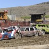 Brandon Weller in the #44 car, the lime green Rough and Tough station wagon, helps to sandwich another car during the Tonasket Demolition Derby presented by the Commancheros Rodeo Club. Weller won three heats and the overall prize as the last car still ru
