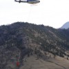 A helicopter, one of four dropping water on the fire on the hillside near the Nighthawk-Chopaka border crossing last Monday afternoon. Photo by Gary DeVon