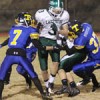 Tonasket's Jeff (7) and John (37) Stedtfeld gang up on a pair of Lakeside players during the Tigers' final game of the season on Friday, Nov. 4.