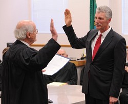 Washington State Supreme Court Justice Gerry Alexander swears in Chris Culp as the new Okanogan County Superior Court Judge in a ceremony held at the commissioners' hearing room last Friday, Dec. 2. Judge Culp, who was appointed to the position by Gov. Ch