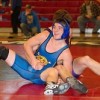 The Tigers' Austin Booker flashes a grin after completing a long-practiced move during a match at Saturday's Omak wrestling tournament.