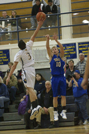 Photo by A.J. BakerThe Hornets' C.J. Mathews flies in to swat away John Stedtfeld's 3-point attempt during Oroville's victory over the Tigers.