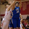 Photo by Brent Baker - The Tigers' Laz Ortega fends off Brewster's Easton Driessen during first round action at the Brewster Christmas Tournament on Thursday, Dec. 29.