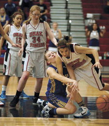Photo by Brent Baker — Devan Utt battles with Omak's Shawnee Covington for a loose ball during the Tigers' loss to the Pioneers on Jan. 19.