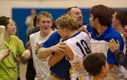 John Stedtfeld (10) is mobbed by teammates, coaches and fans after his buzzer-beater lifted Tonasket to its first CTL victory since 2008.