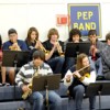 Oroville School Music Director Eric Stiles (far right) accompanies the OHS pep band during the Oroville Hornet Basketball game last Thursday night.