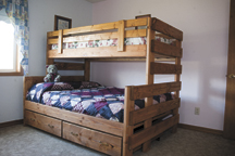 This win over full bunk bed, with storage drawers beneath, is just one of many models the Ensz family builds as part of their newly-opened 1-800-Bunkbed business. Photo by Brent Baker