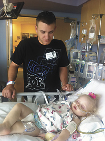 Two days after donating one of his kidneys to his daughter, Hayden, Adam Brazil stands by her side.