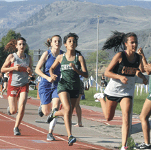 Tonasket's Kylie Dellinger (second from left) used a big final kick to win the district title in the 1600 meter run.