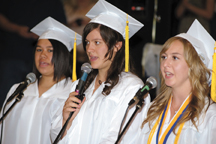 Jasmine Grangroth, Cierra Williams and Co-Valedictorian Michelle Timmerman sing the National Anthem to open Saturday's graduation.