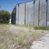 Tonasket city council member Scott Olson (right) envisions a future with a small park, possibly some basketball hoops, murals on the warehouse walls and an improved trail for safe access from town to Chief Tonasket Park, which is beyond the trees at left.