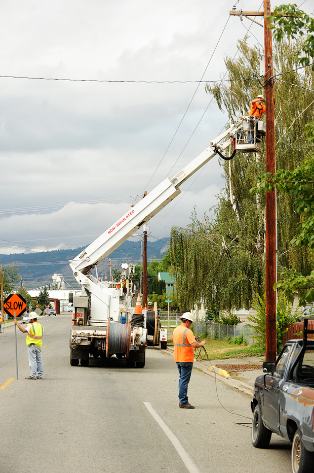 Crews from Spokane-based Potelco were stringing new fiber optic cable along Cherry Street in Oroville last Monday. The new cable is part an Okanogan County PUD project where 180 cable miles of fiber is being installed along Highway 97 from the Canadian Border to Pateros and along Highway 153 from Pateros to the Methow Valley. The project is being paid for through a $9 million American Recovery and Reinvestment Act (ARRA) awarded to the PUD to bolster high speed broadband access in rural America.  Along with the new fiber optic cable, 172 wifi modules, or outdoor access points, are being installed on power poles and one and a half mile intervals. Each of these modules will be connected to a fiber optic line and will provide access to broadband by customers who subscribe to Internet Service Providers (ISPs), retailers, who use the PUD system. Like the current PUD internet system, the PUD will act as wholesalers. "People will be able to subscribe to an ISP and connect to the module to gain access to broadband," said John MacDonald, Network Engineer with the PUD. "We have tested the system and people can expect speeds up to 10 megabits a second from about three-quarters of a mile away from a module." MacDonald said the network is being engineered in such a way that it will not be over-subscribed and slow down access. He said that if some areas have more subscribers a second module may be added in the area to prevent slow-downs from happening. "At this point we are running cable to about Veranda Beach on the east side of the lake and to the Canadian border on the west side," said MacDonald. "We will be going from the north in Oroville to Pateros first, then from Pateros to the Methow." He said there are also plans to run spurs along Havillah Road, up Swanson Mill Road, South Pine Creek and to Loomis, as well as to Wannacut Lake. Gary DeVon/staff photo